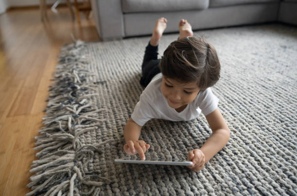 Girl lying on rug flooring | Goetze Bros. Carpet & Furniture